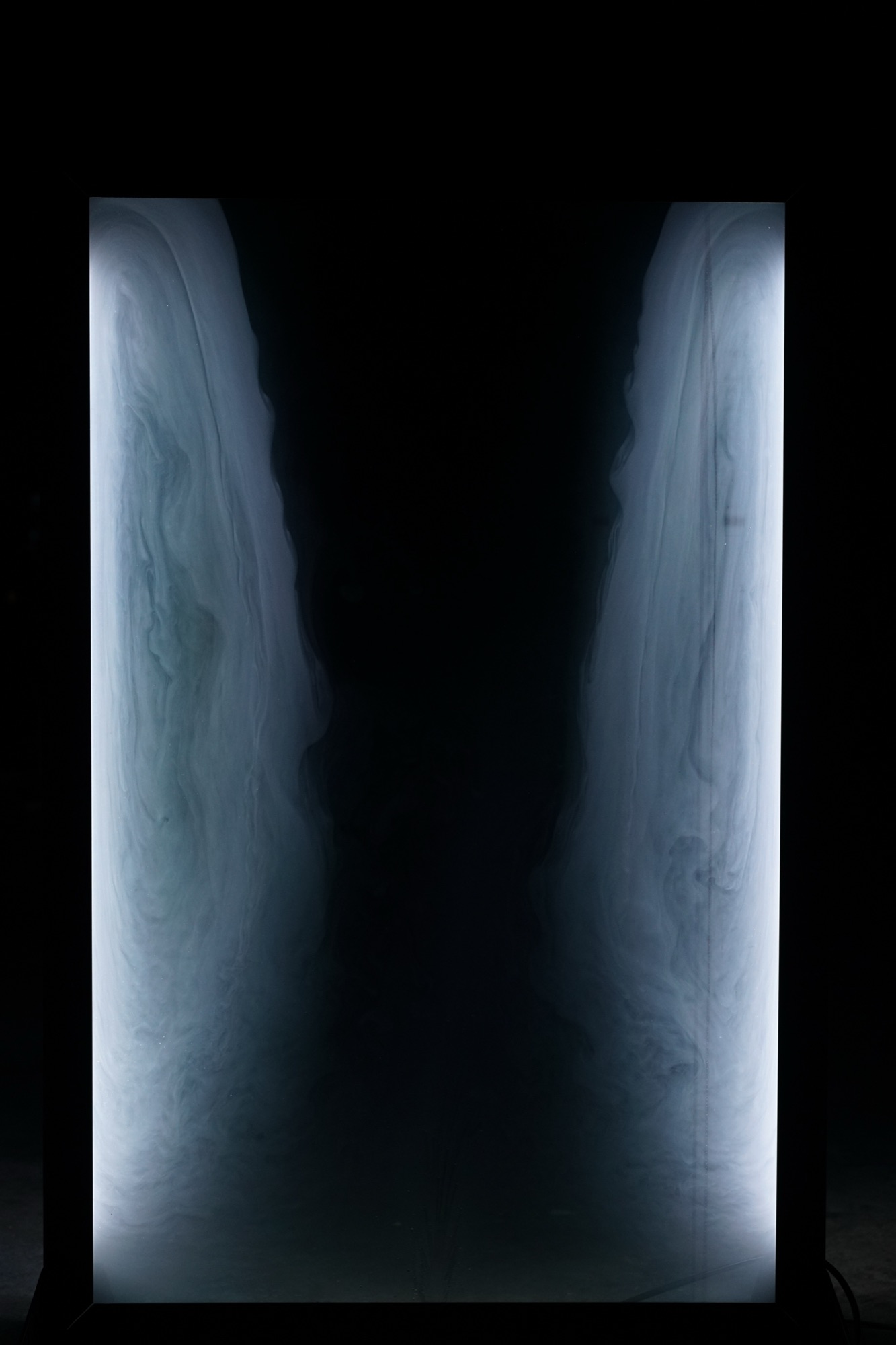 cloud chamber — illuminated fog inside a glass volume